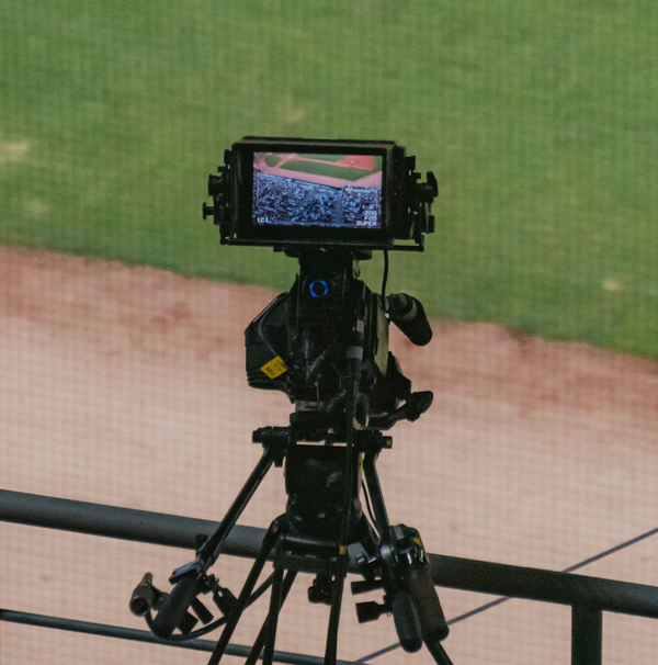 Broadcast camera beside a baseball field
