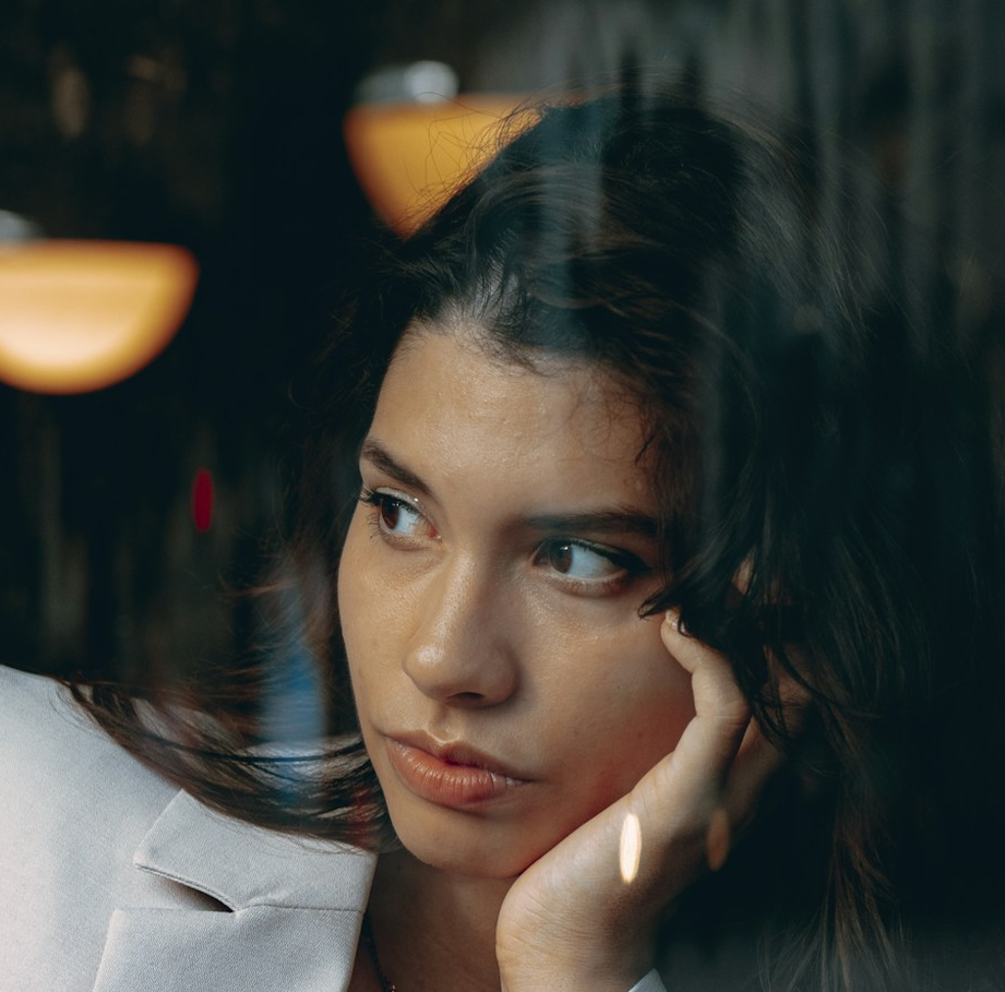 Woman sitting beside a café window